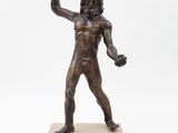 bronze statue of a man holding a baseball bat on a marble base