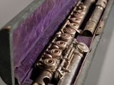 a flute that is in a case on a table