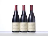 three bottles of wine sitting on top of a table