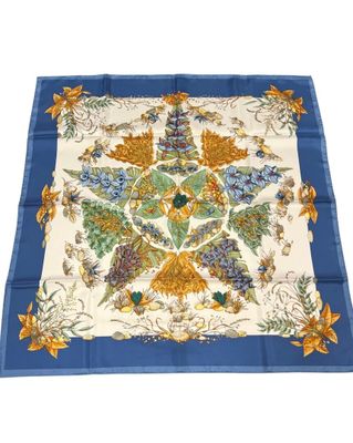 a blue and white square scarf with a floral design