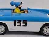 a blue and white toy car with a man in a turban