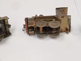 three pieces of metal that have been placed on a white surface