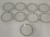 twelve white and black dinner plates with black rims on a white table