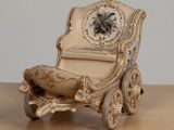 a miniature chair with a clock on it on a table