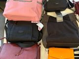 a lot of purses that are sitting on a table