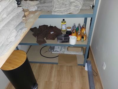 a shelf with bottles and bottles on it in the corner of a room