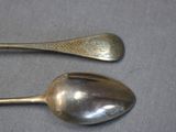two spoons that are sitting on a table