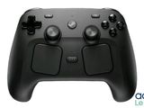 a close up of a black game controller on a white background