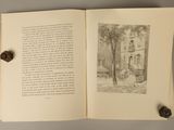 an open book with a drawing of a man sitting on a bench