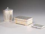 a silver box and a silver lighter on a table