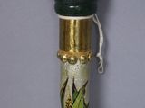 a close up of a wooden stick with a painting on it