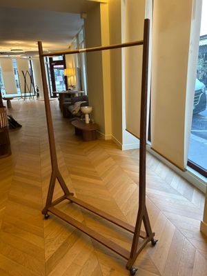 hardwood flooring in a hotel lobby with large windows and a coat rack