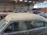 many old cars parked in a garage with a lot of them