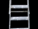 a ladder that is leaning up against a black background