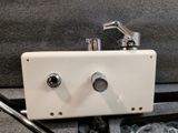 a small white box with a faucet and a pair of scissors