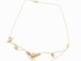 a gold necklace with pearls and a cross on a chain