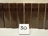 six old books are lined up in a row with a number 30 on them