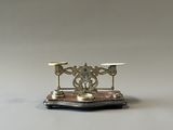 un bougeoir en argent et en or posé sur une table blanche