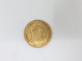 a close up of a gold coin on a white surface