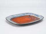 orange and blue plate on white table with white background
