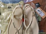 two pairs of sandals and a t - shirt on a table