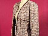 jacket on a mannequin stand against a red background