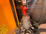 a close up of a machine with a hose attached to it ' s side