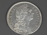 an image of a silver coin with a woman ' s head on it