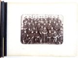 an old photo of a group of men in uniform posing for a picture