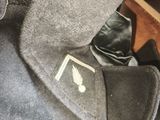 a jacket with a tie and a hat on it