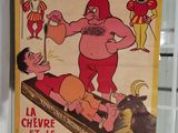 affiche représentant un homme dans une posture de lutte, avec une chèvre devant lui