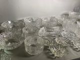 a lot of glass bowls and cups on a table
