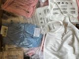 a box full of baby clothes and other items in it