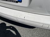 a white car parked in a parking lot next to a parking meter