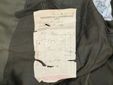 a piece of paper that has been pinned to a jacket