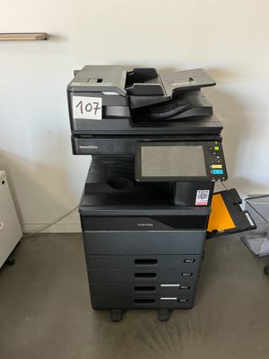 a printer sitting on top of a cart in a room