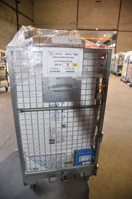 a metal cart with a sign on it in a warehouse