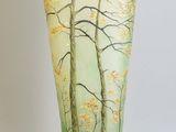 a vase with a painting of trees on it