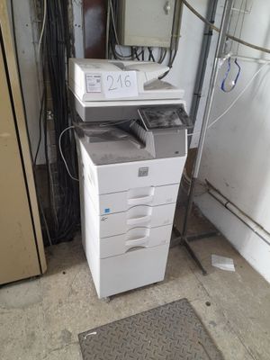 a white printer that is sitting on top of a cabinet