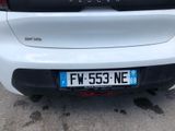 a close up of a white car with a number plate on it