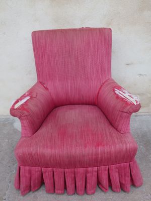 a pink chair with ruffled skirt on it
