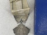 two medals and a book sitting on a table