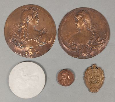 two coins and a coin with a picture of a woman on them