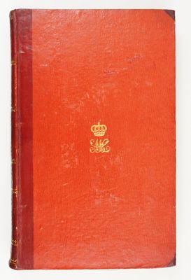 an old red book with a gold crown on top of it