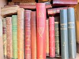 many old books in a box on the shelf