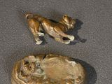 two figurines of a cat and a dog on a table