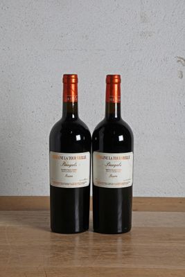 deux bouteilles de vin rouge posées sur une table en bois, à côté d'une bouteille de vin