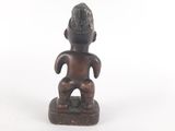 an old wooden statue of a man with a hat on his head
