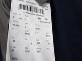 a ticket with a barcode on it hanging from the back of a man ' s jacket