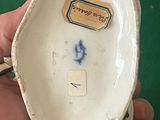 a person holding a small bowl with a sticker on it